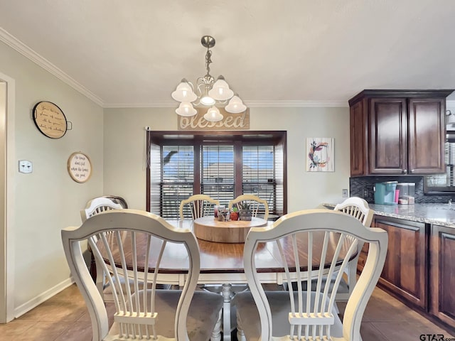 tiled dining area featuring baseboards, ornamental molding, and a notable chandelier