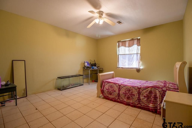 tiled bedroom featuring ceiling fan