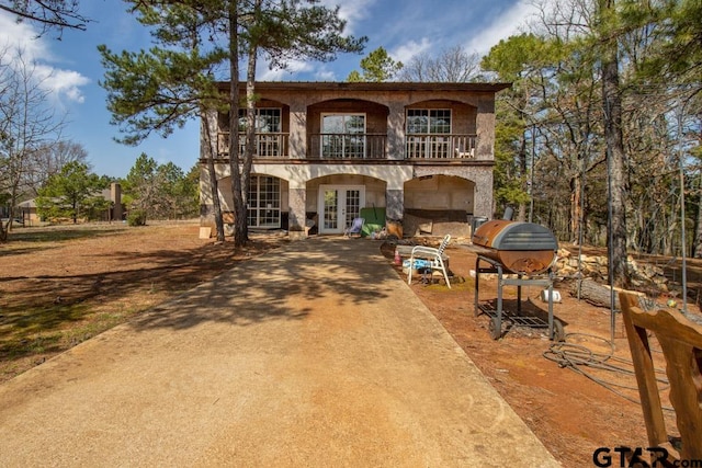 mediterranean / spanish-style house featuring french doors