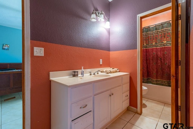 bathroom featuring tile patterned flooring, vanity, and toilet