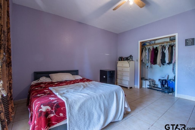 bedroom with a closet, tile patterned floors, and ceiling fan