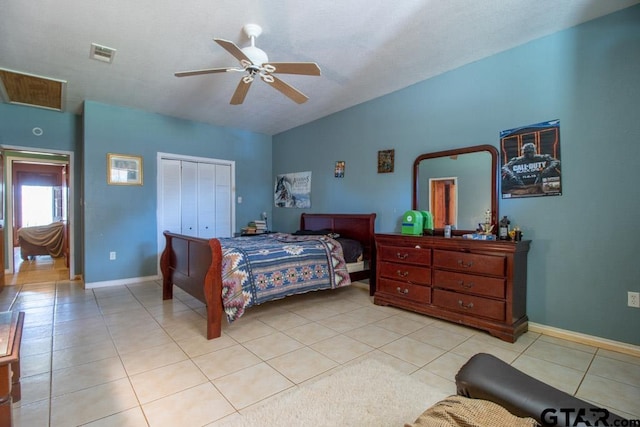 bedroom with light tile patterned floors, ceiling fan, and a closet