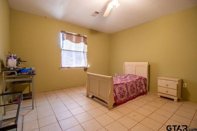 tiled bedroom featuring ceiling fan