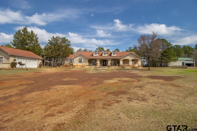 ranch-style house featuring a garage and covered porch