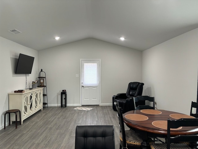 dining space with wood-type flooring and lofted ceiling