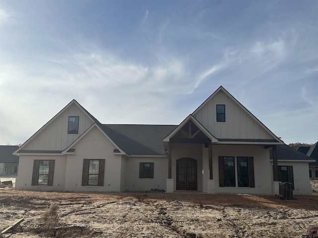 view of front of home with central AC and french doors