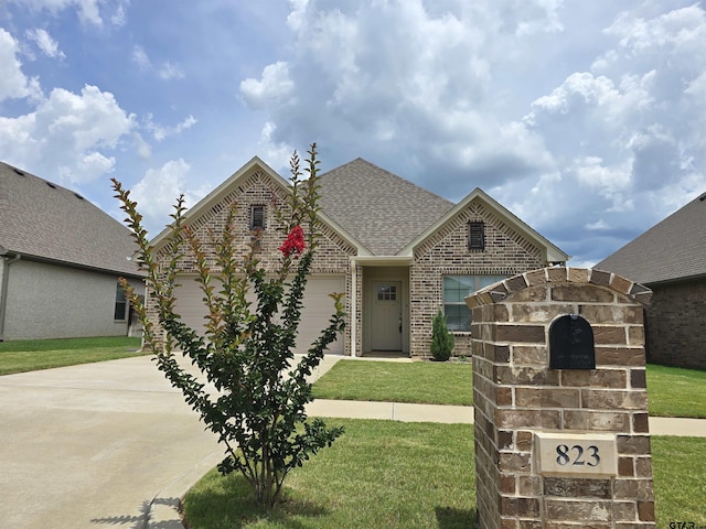 823 Lindsey Ln, Whitehouse, TX 75791 - view of front of house featuring concrete driveway, brick siding, a shingled roof, an attached garage, and a front yard