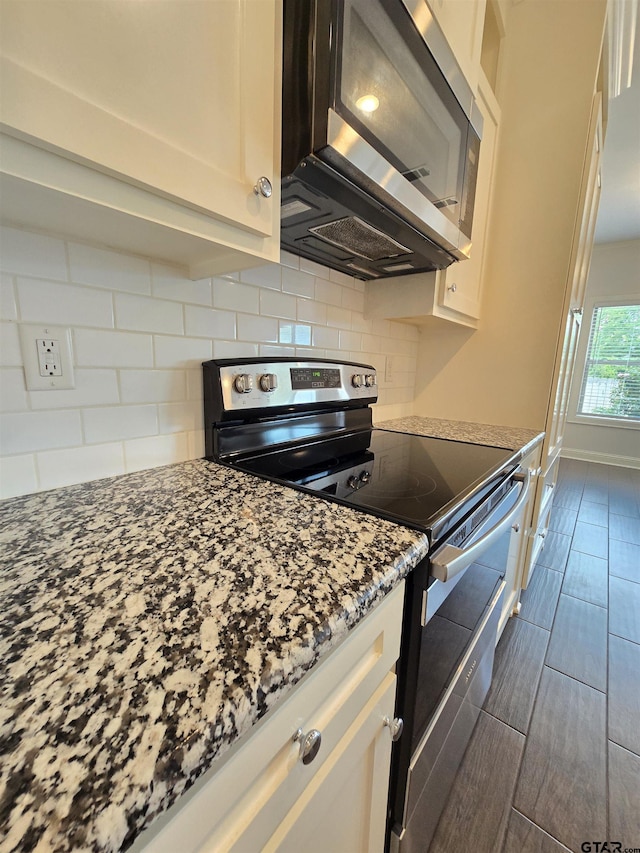 823 Lindsey Ln, Whitehouse, TX 75791 - kitchen featuring stainless steel appliances, tasteful backsplash, light stone countertops, and white cabinets