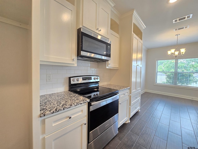 823 Lindsey Ln, Whitehouse, TX 75791 - kitchen with stainless steel appliances, a chandelier, tasteful backsplash, and white cabinetry