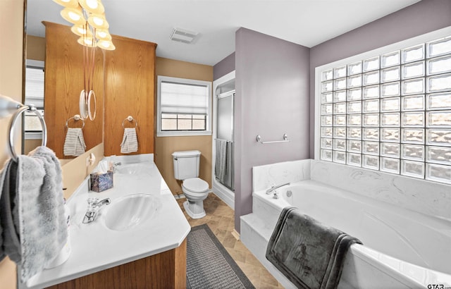 full bath with a sink, double vanity, a shower stall, visible vents, and a bath