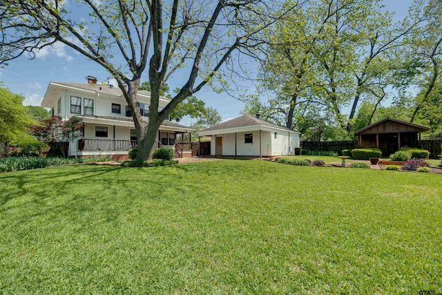 view of yard with fence and an outbuilding