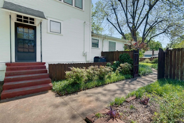 entrance to property with fence and cooling unit