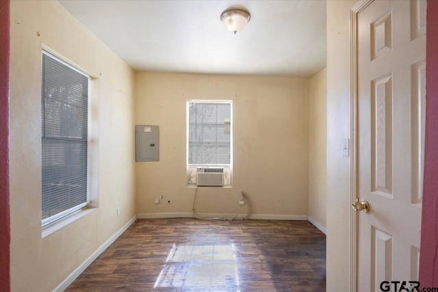 empty room featuring electric panel, dark hardwood / wood-style flooring, and cooling unit