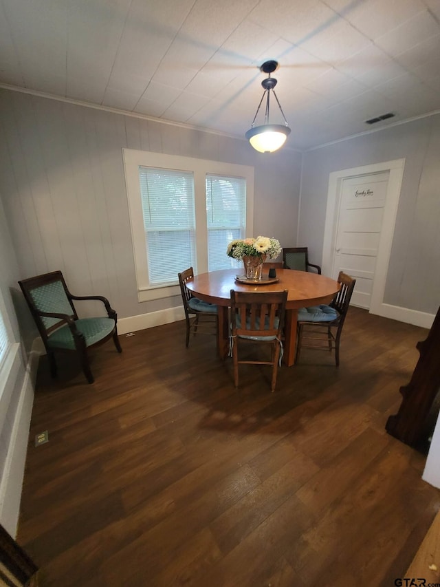 dining area featuring dark hardwood / wood-style flooring and ornamental molding