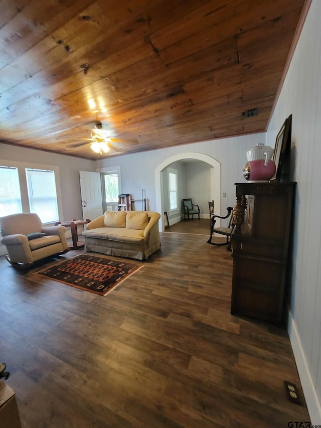 interior space featuring wooden ceiling, ceiling fan, multiple windows, and dark wood-type flooring