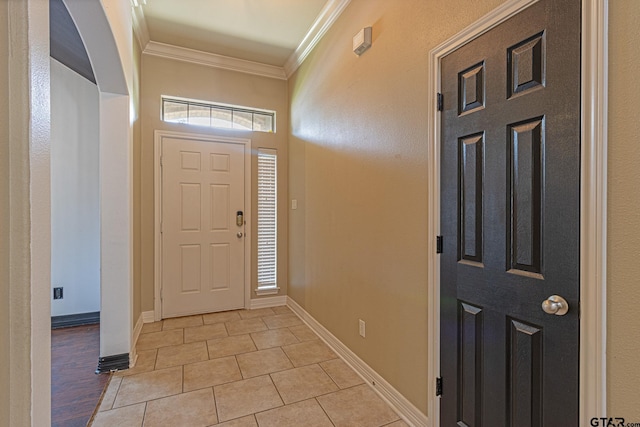 tiled foyer entrance featuring ornamental molding