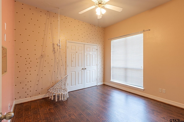 interior space with ceiling fan, lofted ceiling, dark hardwood / wood-style flooring, and a closet