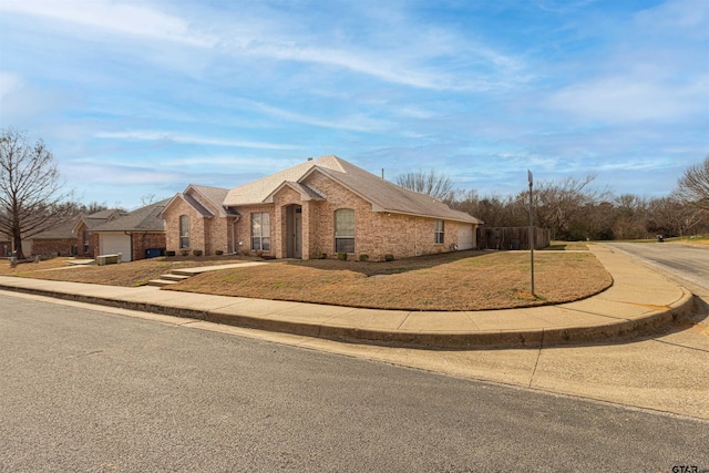 ranch-style house with a garage and a front lawn