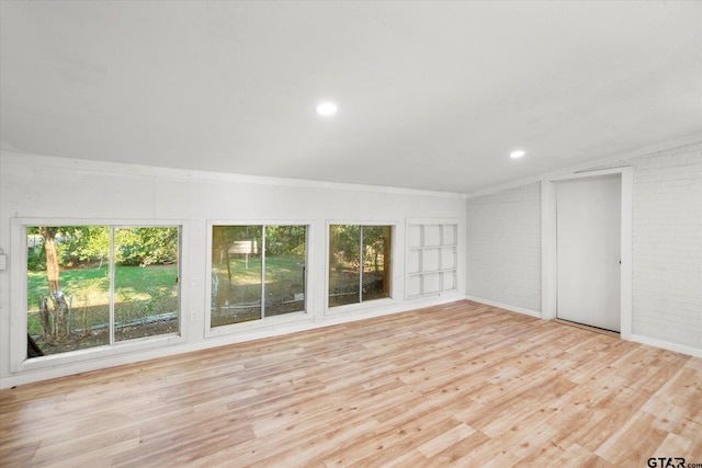 interior space with light hardwood / wood-style flooring and lofted ceiling