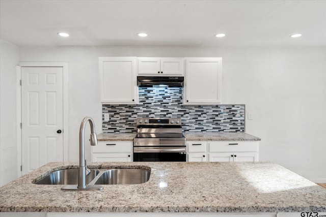 kitchen with white cabinetry, stainless steel electric range, sink, and light stone countertops