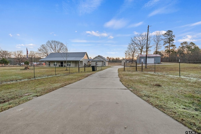 view of property's community with a lawn and an outbuilding