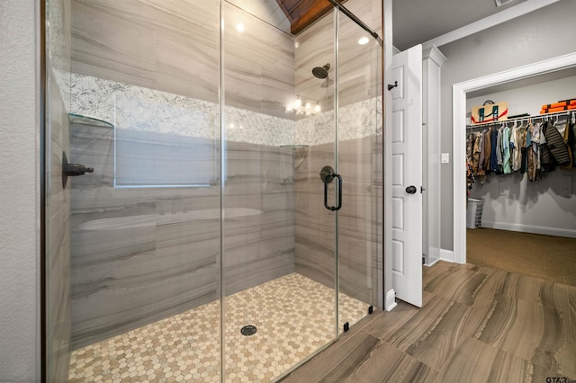 21562 Castle Rock Cir, Bullard, TX 75757 - bathroom featuring a shower stall, a walk in closet, and baseboards