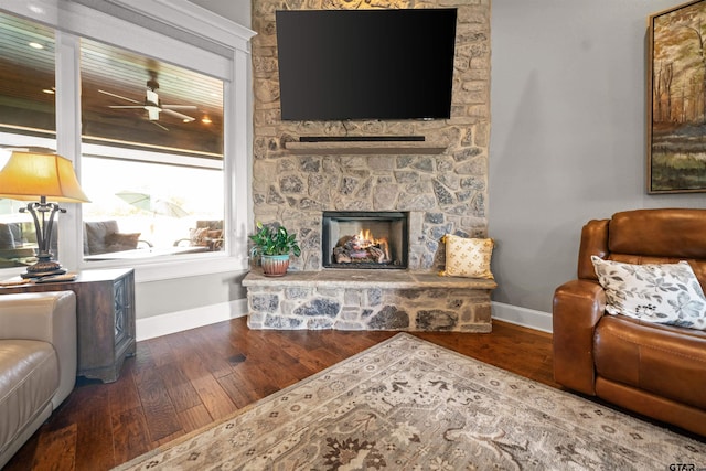 21562 Castle Rock Cir, Bullard, TX 75757 - living room featuring baseboards, wood finished floors, and a stone fireplace