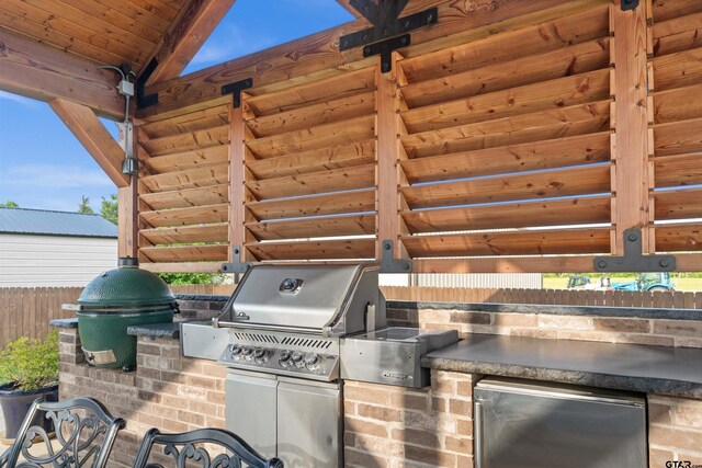 21562 Castle Rock Cir, Bullard, TX 75757 - view of patio with exterior kitchen, fence, and grilling area