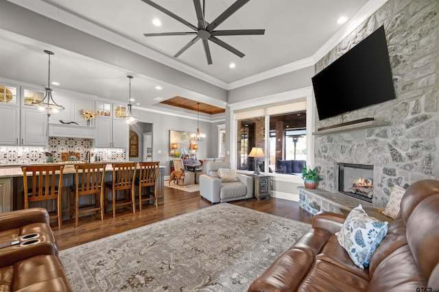 21562 Castle Rock Cir, Bullard, TX 75757 - living area with a ceiling fan, dark wood finished floors, ornamental molding, a fireplace, and recessed lighting