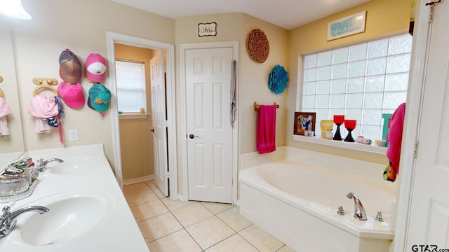 bathroom featuring vanity, a tub, and tile patterned floors