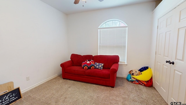 sitting room with light colored carpet and ceiling fan