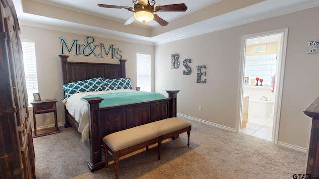 bedroom featuring ornamental molding, light carpet, ceiling fan, and ensuite bathroom