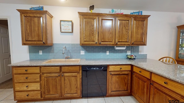 kitchen featuring tasteful backsplash, sink, black dishwasher, and light tile patterned floors