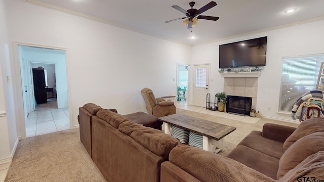 living room with ornamental molding, light tile patterned floors, and a tile fireplace