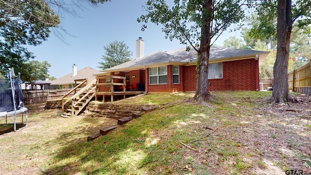 back of house featuring a trampoline