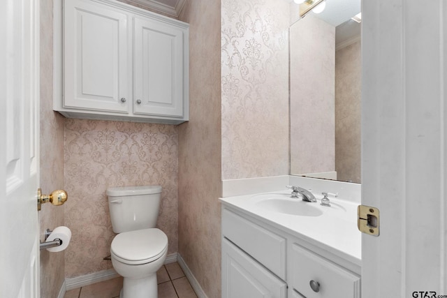 bathroom featuring tile patterned flooring, toilet, vanity, baseboards, and wallpapered walls