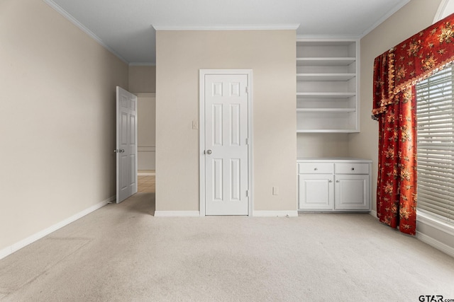 unfurnished bedroom featuring light carpet, crown molding, and baseboards