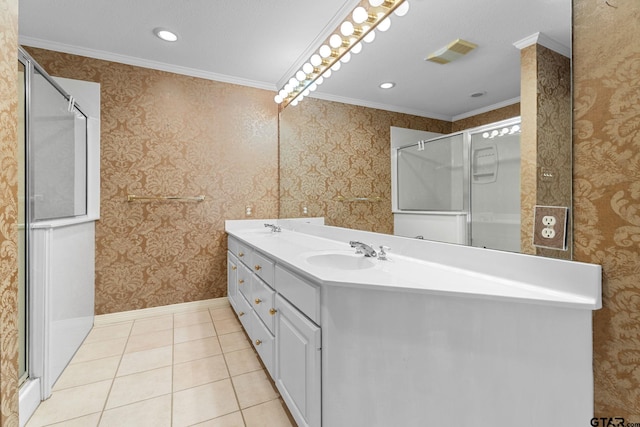 bathroom with tile patterned floors, visible vents, a sink, a shower stall, and wallpapered walls