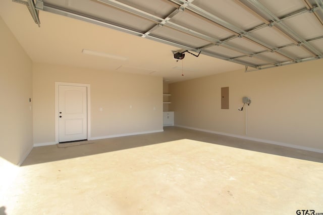 garage featuring electric panel and a garage door opener