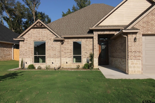 view of front of property featuring a garage and a front yard