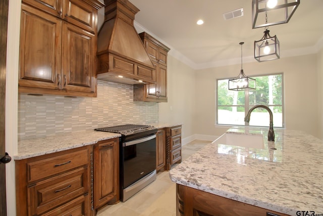 kitchen with light stone counters, sink, custom exhaust hood, stainless steel range, and backsplash