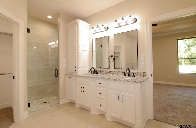 bathroom featuring an enclosed shower and vanity