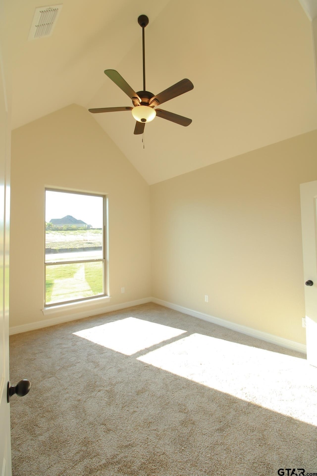 spare room featuring carpet, ceiling fan, and high vaulted ceiling