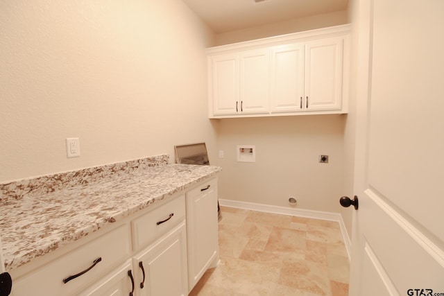 washroom with hookup for an electric dryer, hookup for a washing machine, and cabinets