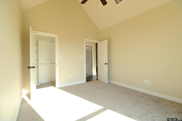 unfurnished bedroom with ceiling fan, light carpet, and high vaulted ceiling