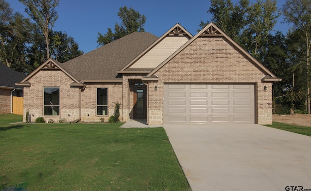 view of front facade featuring a front yard and a garage