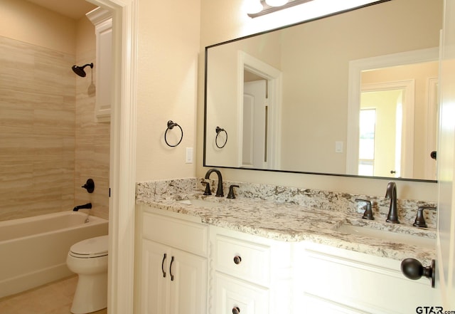 full bathroom with toilet, tiled shower / bath combo, and vanity