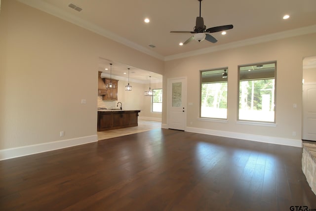 unfurnished living room with ceiling fan, dark hardwood / wood-style floors, and crown molding