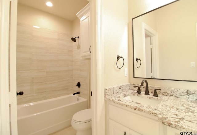 full bathroom with toilet, tiled shower / bath combo, and vanity