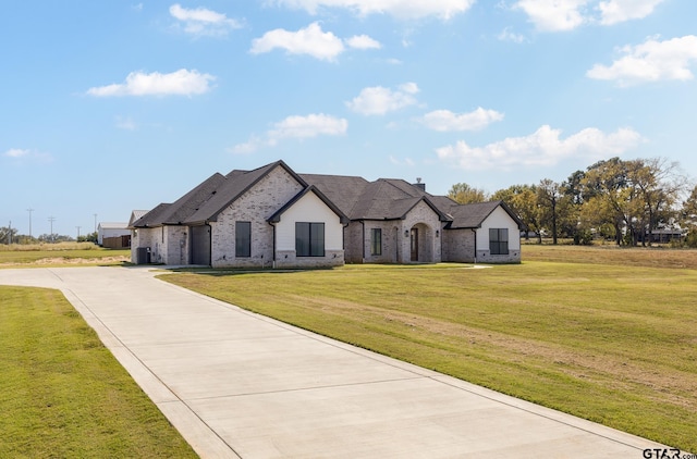 french provincial home with a front lawn